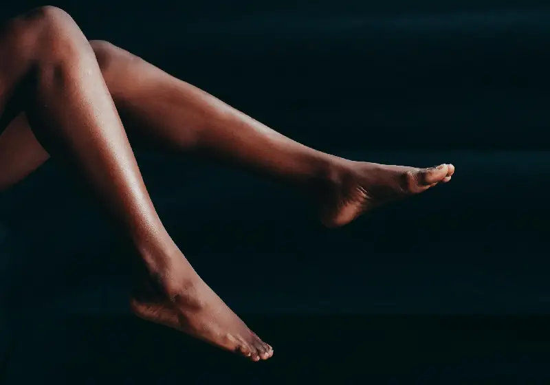 A Person's Legs and Feet Pointing Upwards