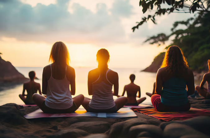 a group of women sitting in yoga pose